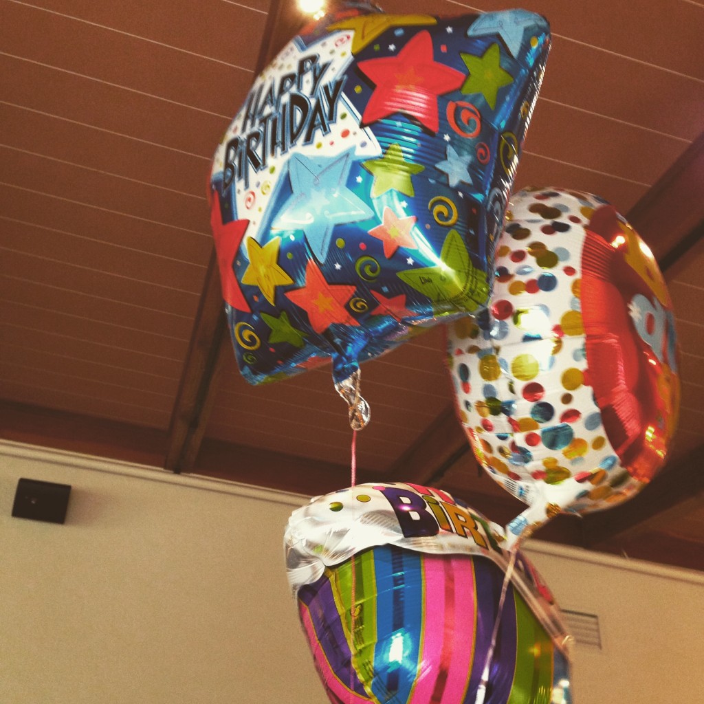 Balloons from a joint birthday celebration during the day.