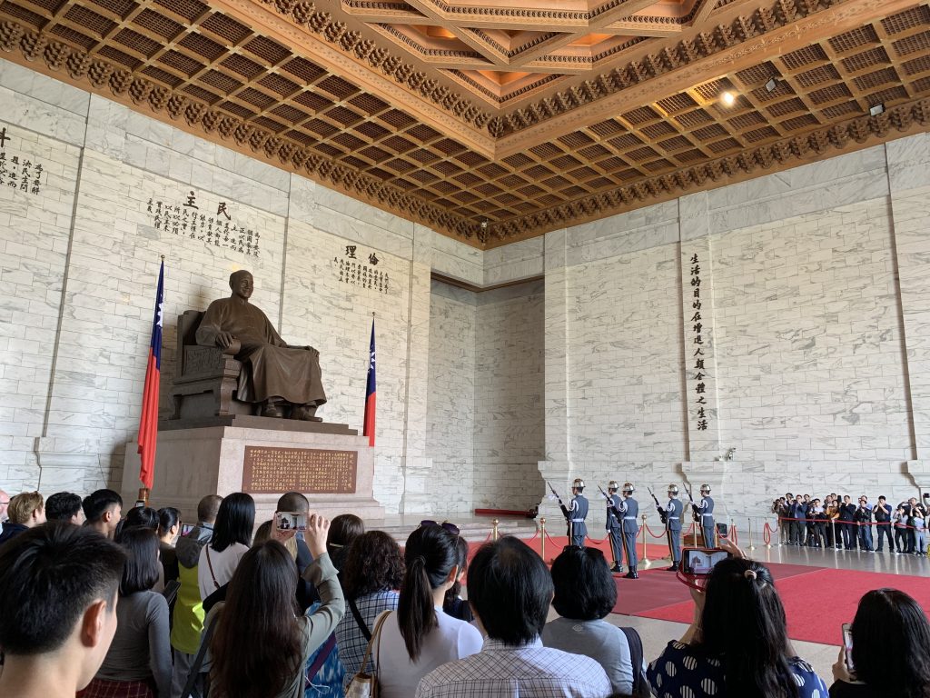 Guards perform a ceremony for the public in front of the Chiang Kai-Shek memorial statue.