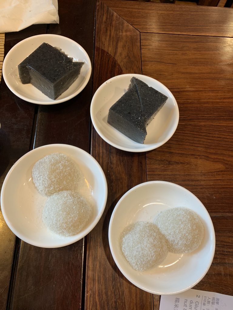 Black sesame dessert cut into triangles and peanut dumplings are two types of vegetarian dim sum in Hong Kong.