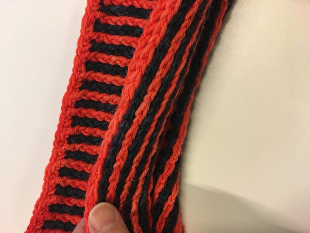 Orange and dark gray yarn alternating in rows.